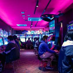 A colorful arcade with several patrons