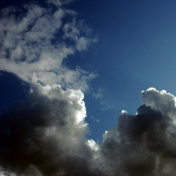 Dark clouds beginning to roll over a bright sky